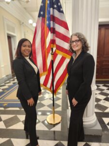 Danielle Neal with Jenny Collier standing by a US Flag in the US Capitol, 2024